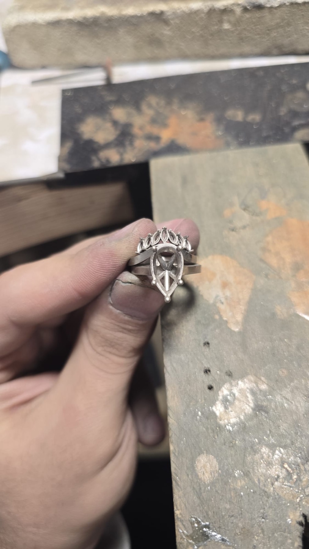A ring being set by hand at the jeweller's bench